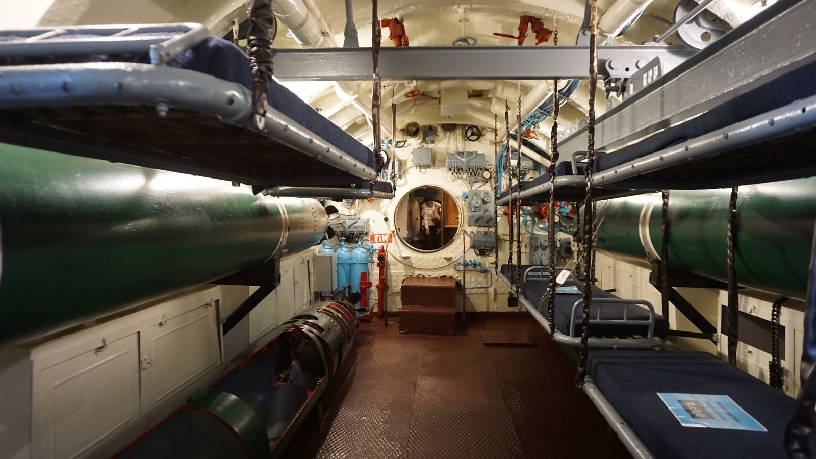 Navy submariners working near lagged pipes, illustrating submarine service asbestos exposure