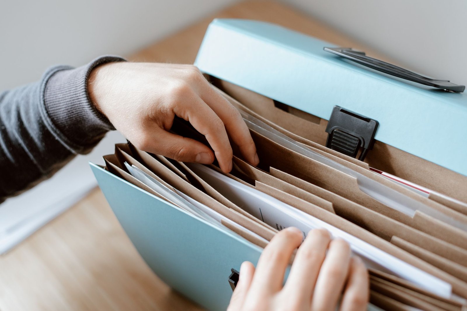 Hands organizing medical evidence to help resolve a VA claim deferred decision