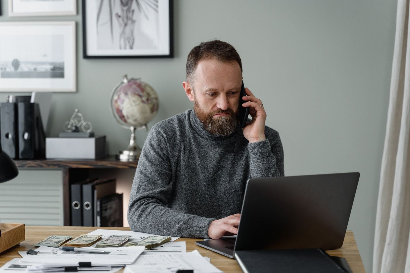 Veteran at home keeping notes on VA duty to assist steps like scheduling a claim exam and requesting records