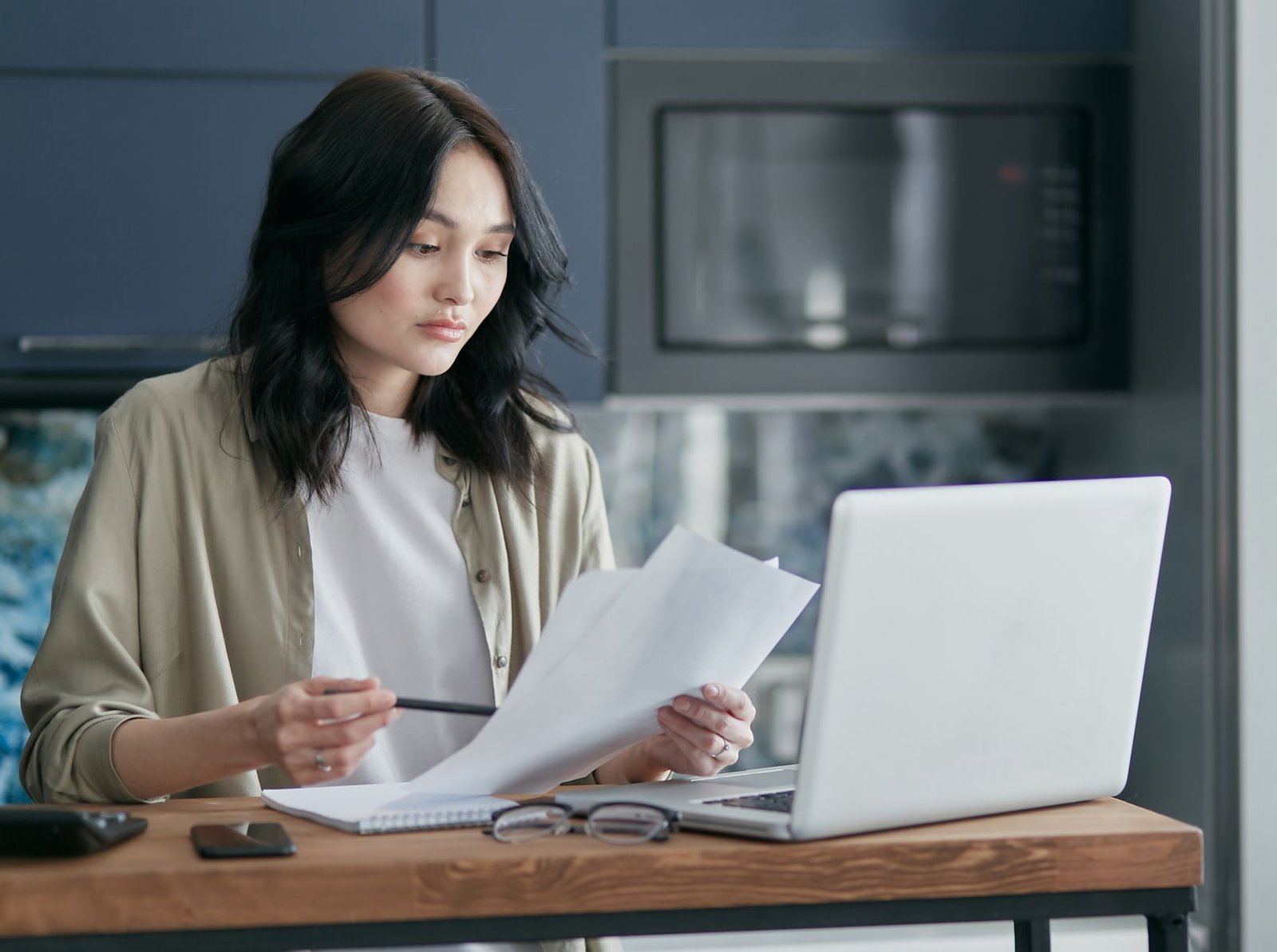 Surviving spouse reviewing paperwork related to the VA month of death benefit at home