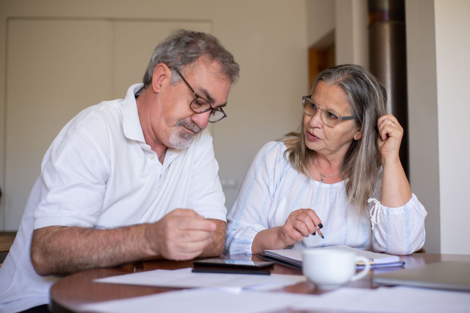 Veteran couple discussing VALife insurance for disabled veterans coverage options at home