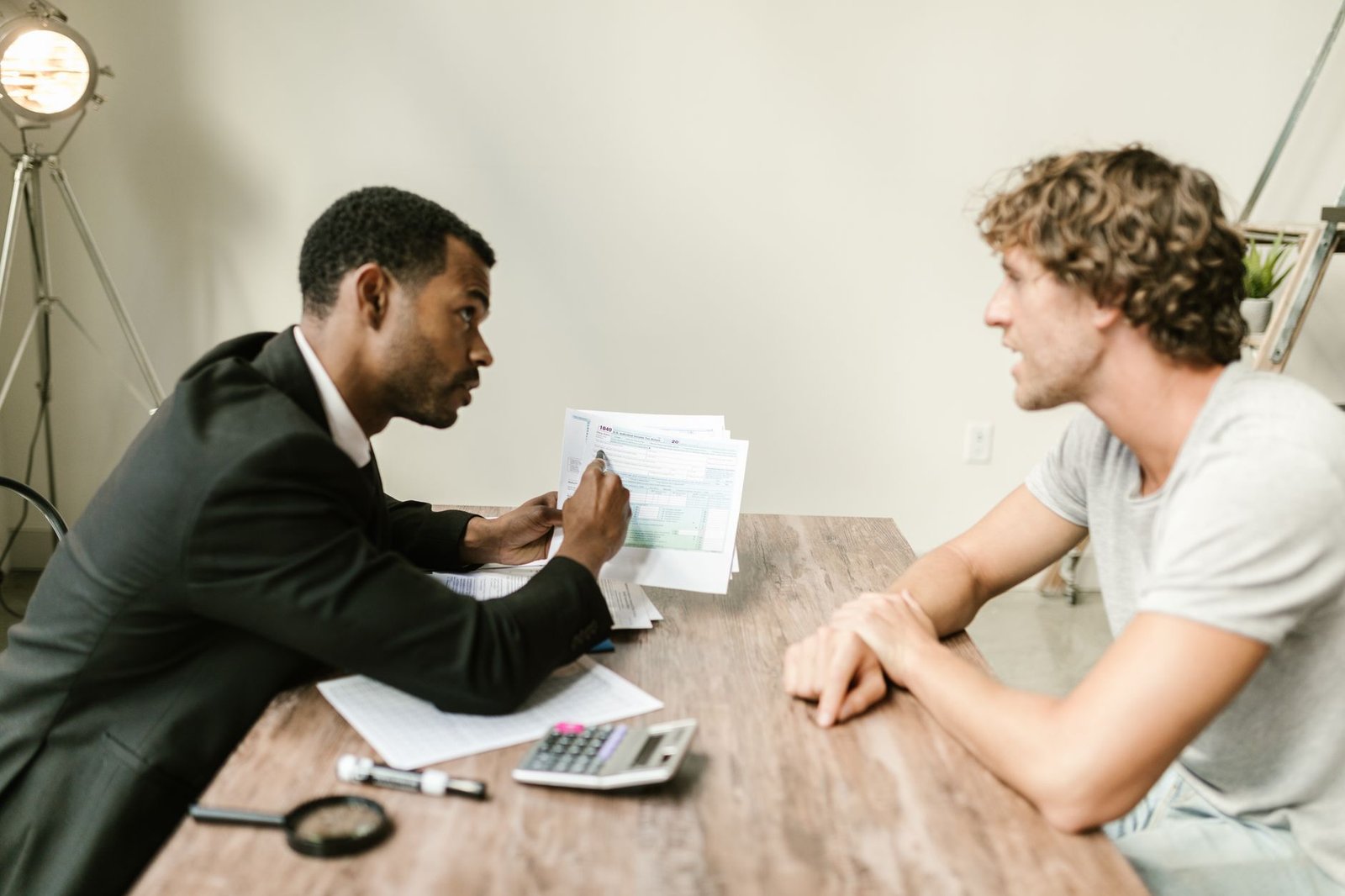 Veteran discussing the VA duty to assist with a benefits advisor while reviewing claim documents