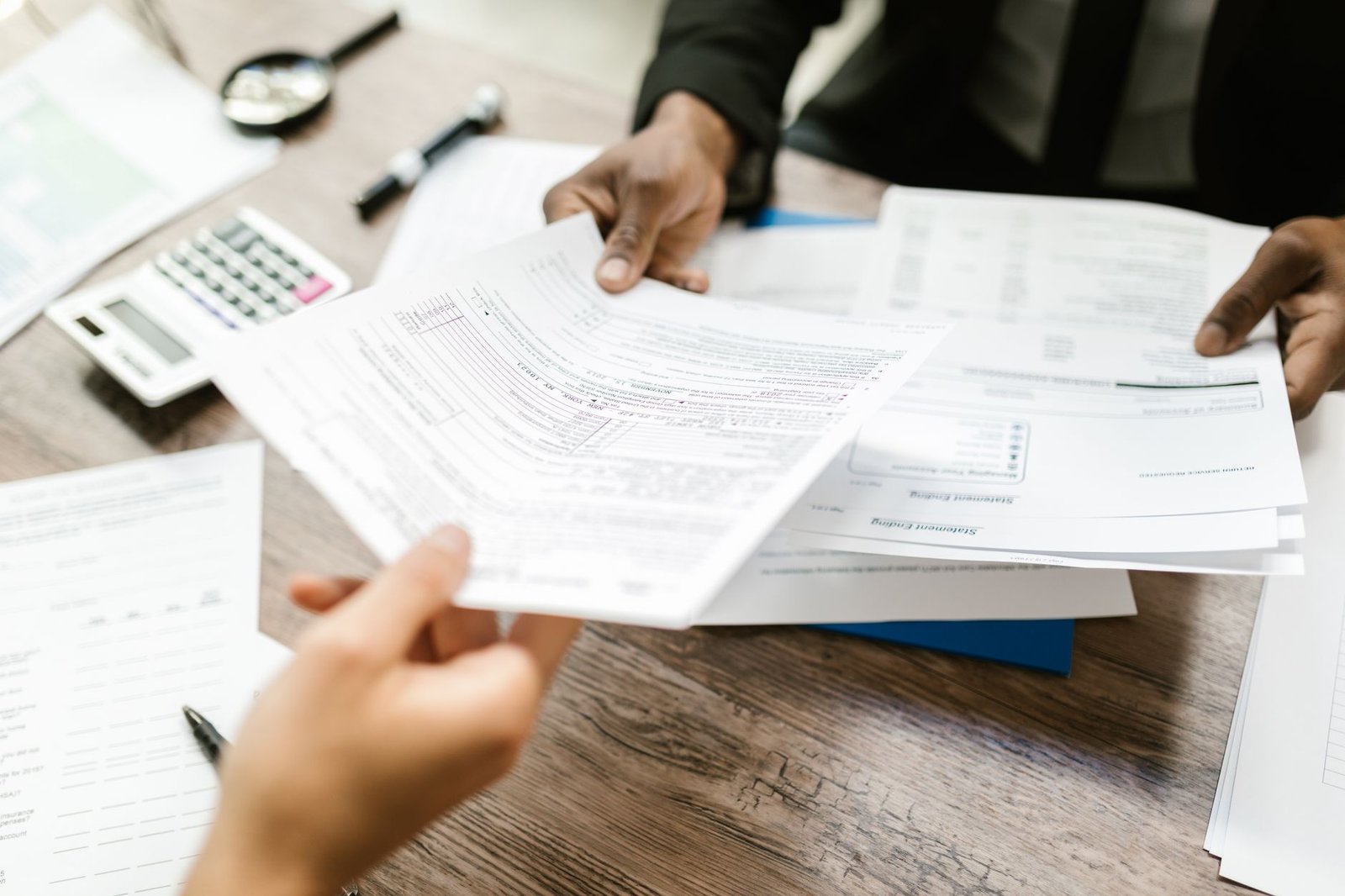 Hands completing an application, part of understanding VALife insurance for disabled veterans