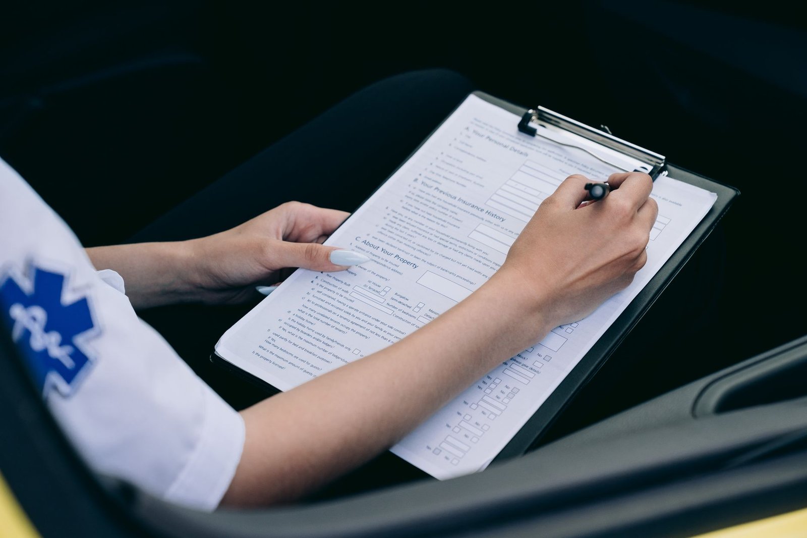 Hands completing paperwork, part of preparing a VA fully developed claim for asbestos exposure