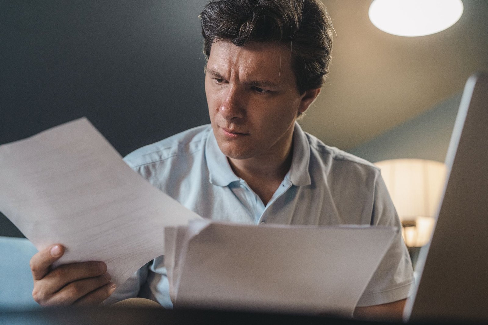 Veteran reviewing VA disability protected ratings paperwork at a home desk